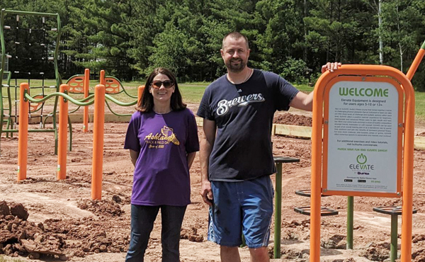 Man and woman standing on playground construction site